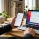 Person holding smartphone open to wireless settings next to laptop on desk