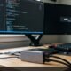 Modern dual monitor desk setup with USB-C hub showing one active display and second monitor displaying no signal