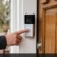 Person pressing the button on a Ring video doorbell to test the chime ring