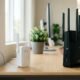 WiFi booster vs WiFi extender hardware comparison showing an extender next to a router